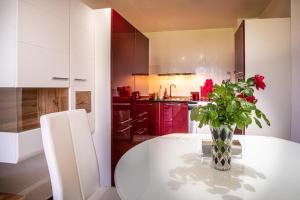 a kitchen with a table with a vase of flowers on it at Luxury Apartment Sea Garden- Building of the Year K55 in Varna City