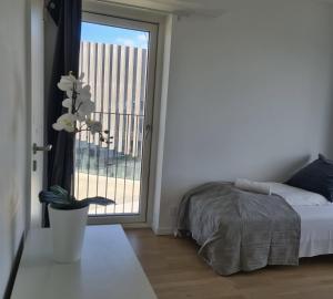 a bedroom with a bed and a large window at Modern Spacious 3 Bedroom Apartment With Balcony At Richard Mortensens Vej Close To The Royal Arena And Fields in Copenhagen