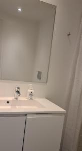 a white bathroom with a sink and a mirror at Modern Spacious 3 Bedroom Apartment With Balcony At Richard Mortensens Vej Close To The Royal Arena And Fields in Copenhagen