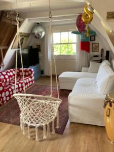 a living room with a swing in a room at Petite city center loft on Amstel river in Amsterdam