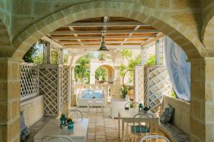 an archway in a patio with tables and chairs at B&B Tenuta Martinelli in Monopoli