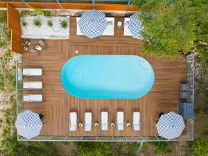 an overhead view of a swimming pool with umbrellas at The Bygone in Wimberley