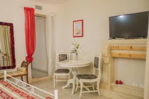 a living room with a table and a fireplace at B&B Tenuta Martinelli in Monopoli