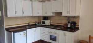 a kitchen with white cabinets and a sink at Apartamento La Playa in Valle Gran Rey +39 photos