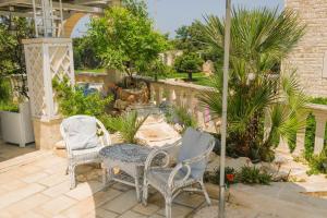 a patio with two chairs and a table at B&B Tenuta Martinelli in Monopoli