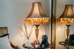 a lamp on a table next to a mirror at Hotel Schiller in Bietigheim-Bissingen