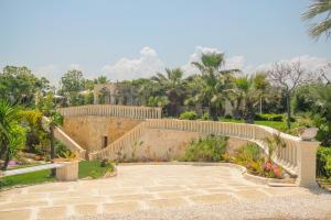 a staircase leading to a house with palm trees at B&B Tenuta Martinelli in Monopoli