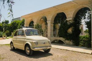 an old car parked in front of a building at B&B Tenuta Martinelli in Monopoli