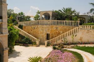 an external view of a house with stairs and flowers at B&B Tenuta Martinelli in Monopoli