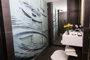 a bathroom with a shower and a sink at Renaissance Santiago by Marriott in Santiago