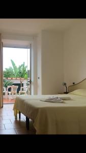 a bedroom with a bed and a view of a patio at Hotel Casa Gerardo in Ischia