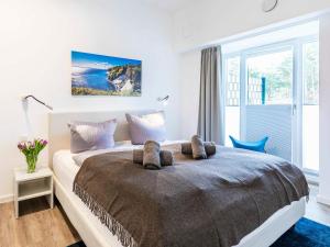 ein Schlafzimmer mit einem großen Bett und einem Fenster in der Unterkunft FeWo Prora - Sundream in Binz
