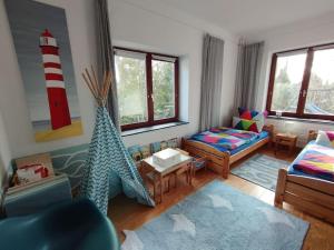 a living room with a couch and a red and white lighthouse at Ferienwohnung Birklund in Probsteierhagen