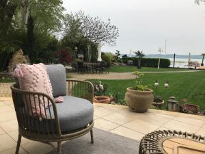 a chair on a patio with a view of a yard at Viktoria House in Balatonszárszó