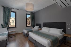 Voodi või voodid majutusasutuse Hotel dei Gonzaga, MantegnaHotels toas