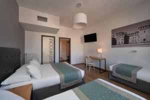 Voodi või voodid majutusasutuse Hotel dei Gonzaga, MantegnaHotels toas