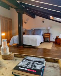 a bedroom with a bed and a book on the floor at La Infinita Rural Boutique in Carmona