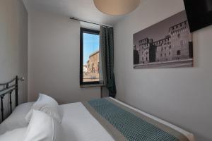 Voodi või voodid majutusasutuse Hotel dei Gonzaga, MantegnaHotels toas