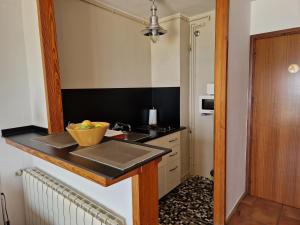 a kitchen with a sink and a counter at Apartamentos Wundermar in Torredembarra