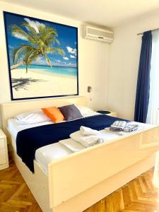 a bedroom with a bed with a picture of a beach at Villa Mare & Filip 2 in Zaton
