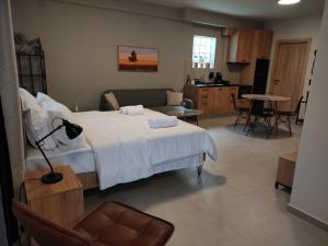 a bedroom with a bed and a living room at Cruzeto in Syvota