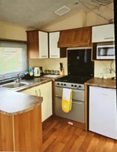 a kitchen with a stove and a sink at Rio Plot F in Torquay