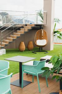 a room with a table and chairs and stairs at Hotel Taburiente S.C.Tenerife in Santa Cruz de Tenerife