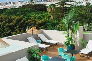 a balcony with chairs and a view of a city at Hotel Taburiente S.C.Tenerife in Santa Cruz de Tenerife
