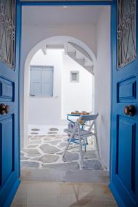 a blue door leading into a room with a table at Nice & Cosy Mykonos studios in Megali Ammos