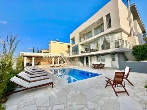 a villa with a swimming pool and a house at Amazing Luxury Villa Larnaca in Aradhippou