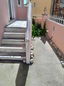 a set of stairs leading up to a pink house at Beach,surf, hiking and more in Maceira
