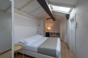 a bedroom with a large white bed and a desk at Residenza Accademia in Mantova