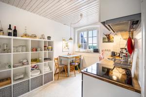 a kitchen with white shelves and a table in it at Klosterhof Eggenreute in Wangen im Allgäu