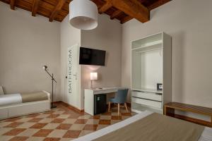 a bedroom with a bed and a desk with a computer at Residenza Accademia in Mantova