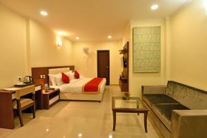 a hotel room with a bed and a couch at Clarks Residences, Nainital in Nainital