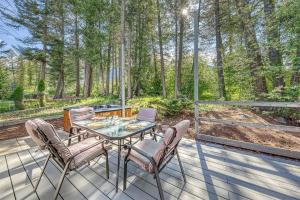 a patio with a table and chairs on a deck at Fairmont Hot Springs, 3 Bedroom Vacation Home in Fairmont Hot Springs