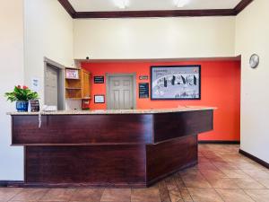 a bar in a hotel lobby with an orange wall at Hotel Zion Inn, Zion National Park Area in Hurricane