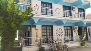 a blue and white building with bikes parked in front of it at Nitsas studio's in Kremasti