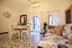 a living room with a table and a couch at Casa De Rosa in Atrani