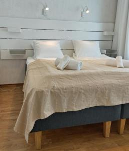 a bedroom with a large bed with two white pillows at Asuntos-2 in Lahti