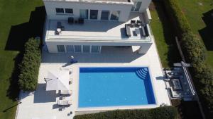 an overhead view of a house with a swimming pool at Lusso Mare Istria Luxury Beach villa in Savudrija
