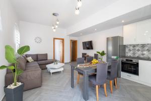 a living room with a couch and a table at Alex Luxury Downtown House in Naxos Chora