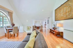 a living room with a couch and a table at Morgado - River Suites and Houses by PCH in Padrões