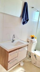 a bathroom with a sink and a toilet at Apartamento Anna Carolina in Florianópolis