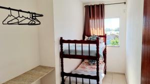 a bunk bed in a room with a window at Apartamento Anna Carolina in Florianópolis