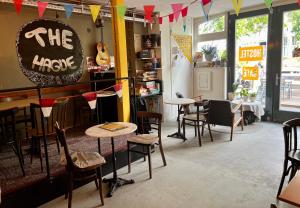 a restaurant with tables and chairs and a sign on the wall at Hostel The Golden Stork in The Hague