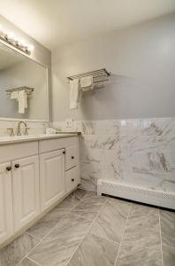 a white bathroom with a sink and a mirror at Hamilton Village Inn in North Kingstown +83 photos
