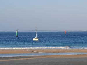 two boats in the water on a beach at Hôtel Ker-Noyal Quiberon Plage in Quiberon
