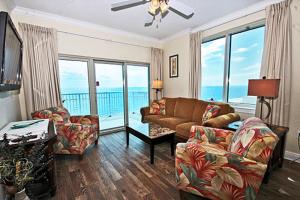 a living room with a couch and chairs and windows at Crystal Tower 1509 by ALBVR - Luxurious 15th Floor Condo with Breathtaking Views in Gulf Shores