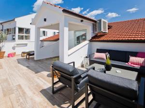 a patio with two chairs and a building at Apartments Bubalo in Hvar